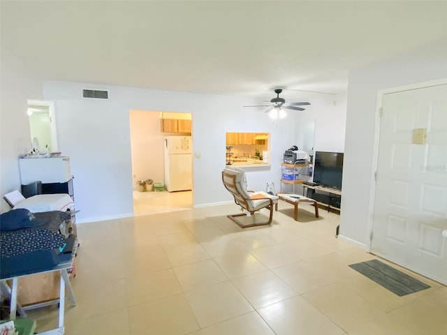 2643 Pine Ridge Way S Unit A1, Palm Harbor, FL 34684 - living area featuring light tile patterned floors, visible vents, a ceiling fan, and baseboards