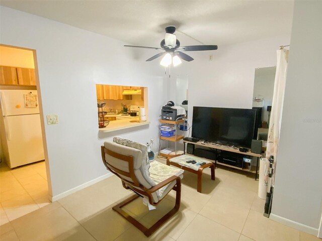 2643 Pine Ridge Way S Unit A1, Palm Harbor, FL 34684 - living room with light tile patterned floors, ceiling fan, and baseboards