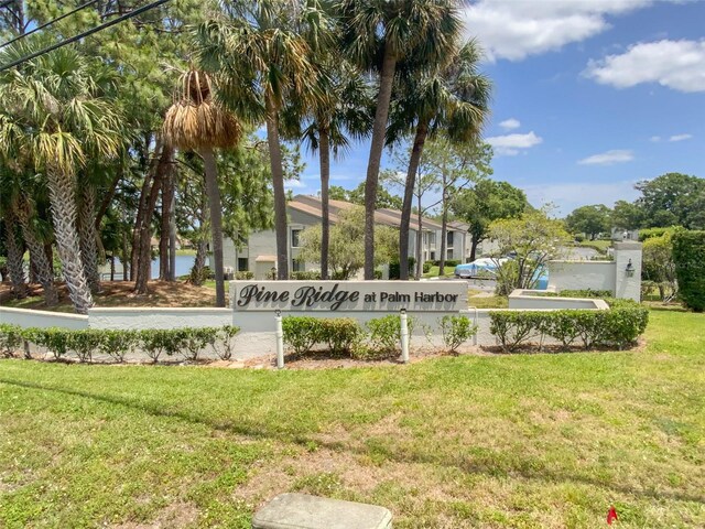 2643 Pine Ridge Way S Unit A1, Palm Harbor, FL 34684 - community sign featuring a lawn and a water view