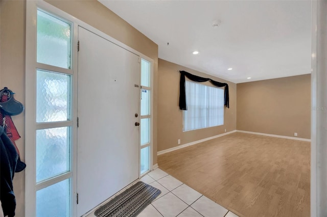 entrance foyer featuring recessed lighting, baseboards, and light tile patterned floors