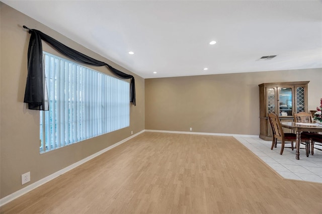 unfurnished living room featuring visible vents, recessed lighting, light wood-style floors, and baseboards