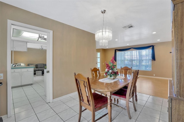 dining space featuring visible vents, baseboards, a chandelier, and light tile patterned flooring