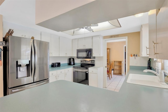 kitchen with ceiling fan, appliances with stainless steel finishes, a sink, light countertops, and white cabinetry