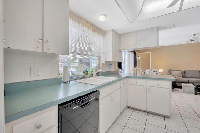 kitchen featuring a sink, black dishwasher, open floor plan, decorative backsplash, and light tile patterned floors