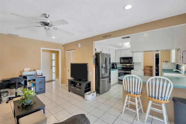 living room featuring light tile patterned flooring, ceiling fan, visible vents, and recessed lighting