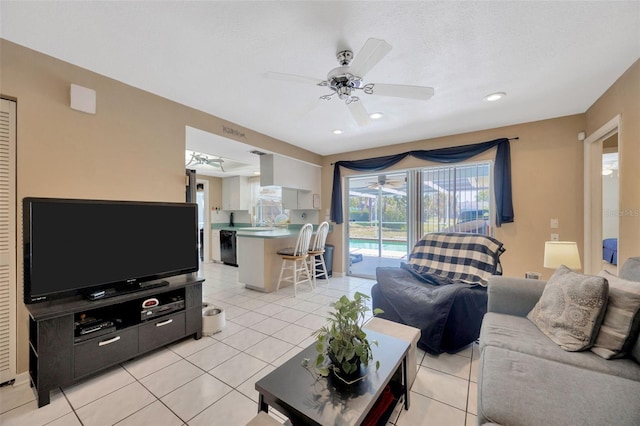 living area with recessed lighting, a ceiling fan, and light tile patterned floors