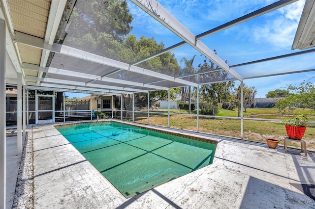 pool featuring a lawn, a lanai, a fenced backyard, and a patio area