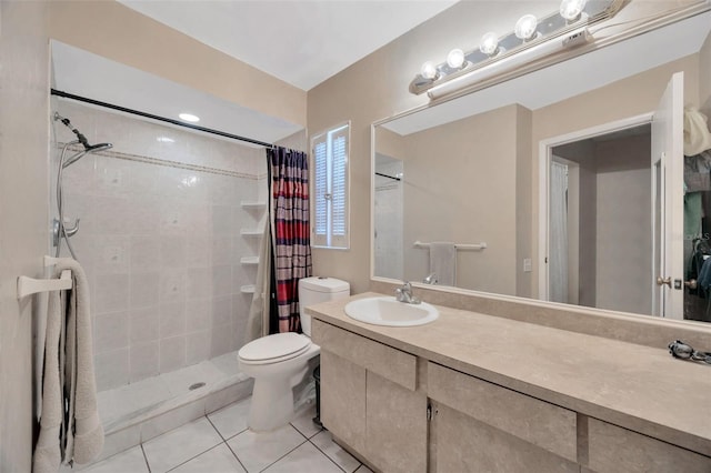 full bath with tile patterned floors, vanity, toilet, and tiled shower