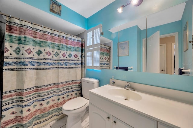 full bathroom featuring toilet, curtained shower, tile patterned flooring, and vanity