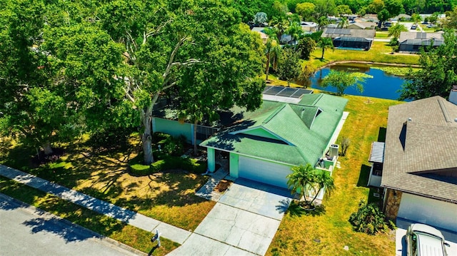 drone / aerial view with a residential view and a water view