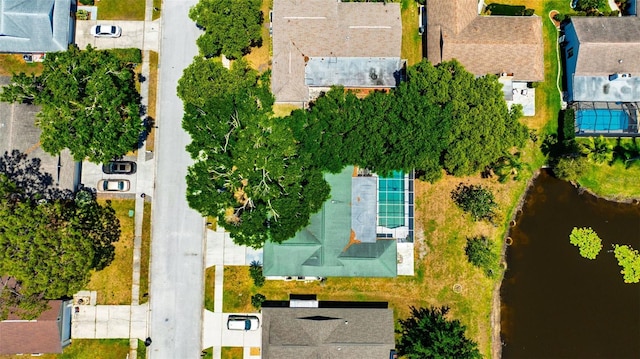 drone / aerial view with a water view and a residential view