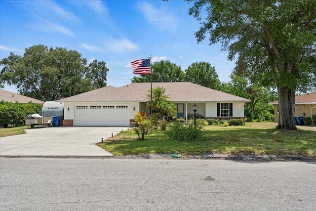 ranch-style house with driveway, a front yard, and a garage