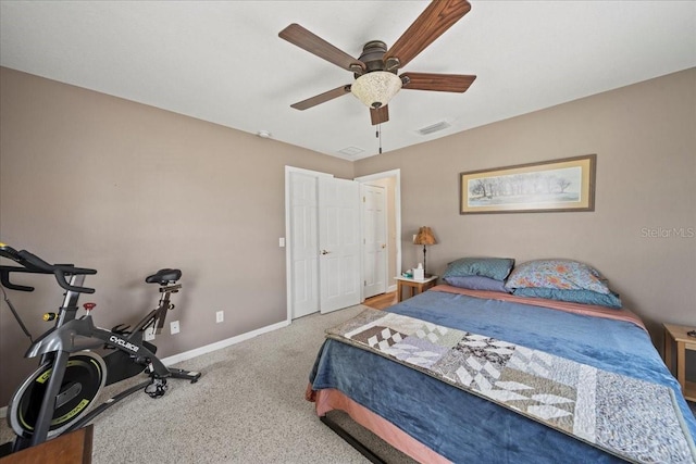 carpeted bedroom featuring visible vents, a ceiling fan, and baseboards