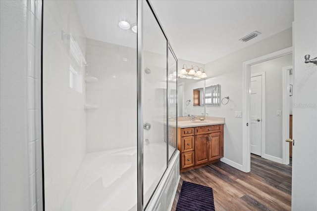 bathroom with vanity, visible vents, and wood finished floors