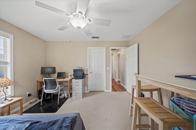 carpeted bedroom featuring visible vents, ceiling fan, and baseboards