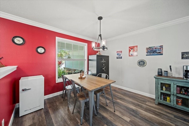 dining space with ornamental molding, wood finished floors, and baseboards