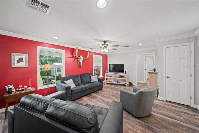 living area featuring visible vents, wood finished floors, a ceiling fan, and ornamental molding