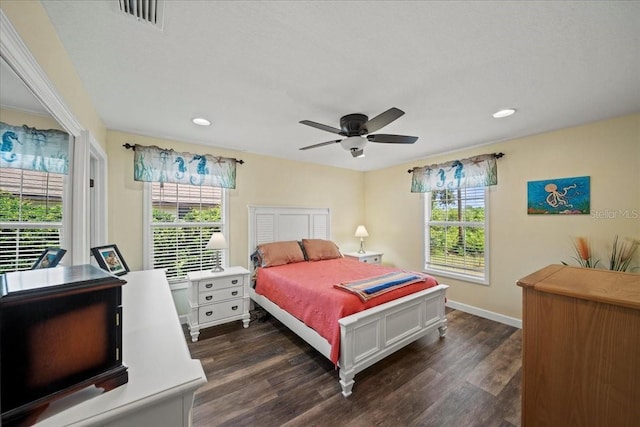 bedroom with visible vents, dark wood-style flooring, multiple windows, and recessed lighting