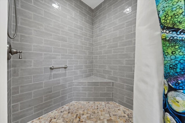 full bath with a tile shower