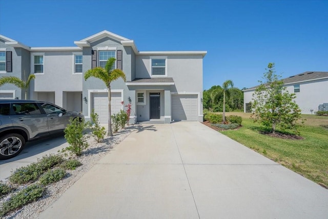 view of front of house featuring a garage, stucco siding, and driveway