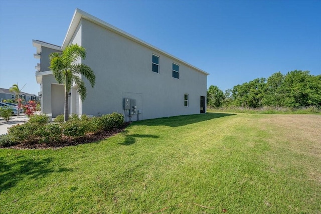 view of home's exterior featuring a lawn and stucco siding