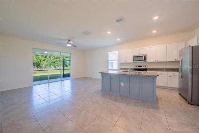 kitchen with visible vents, open floor plan, appliances with stainless steel finishes, and light tile patterned floors
