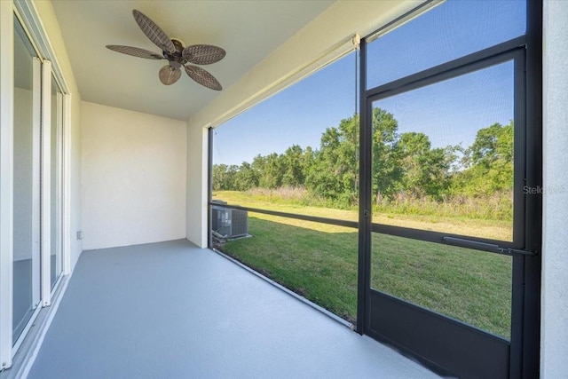 unfurnished sunroom with ceiling fan