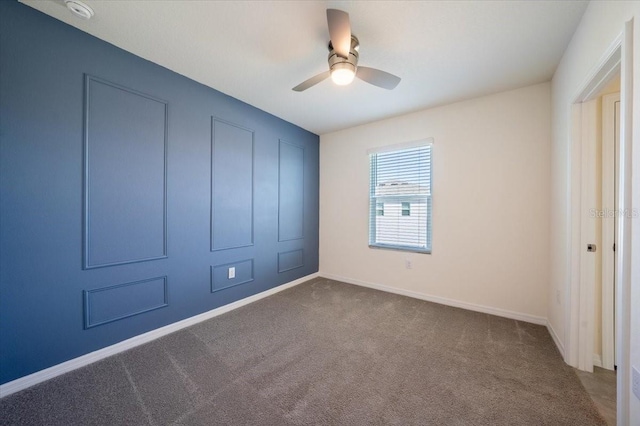 unfurnished bedroom featuring carpet floors, baseboards, and ceiling fan