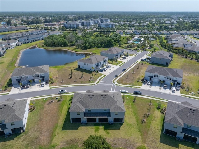 drone / aerial view with a residential view and a water view