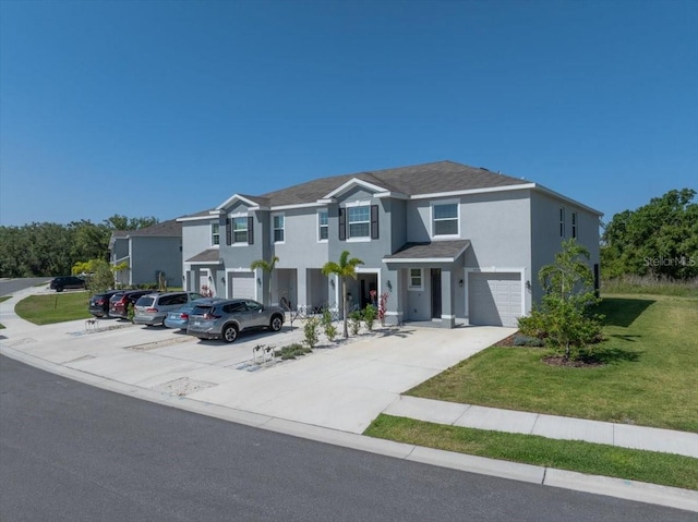 view of front of property featuring a garage, a front lawn, stucco siding, and driveway