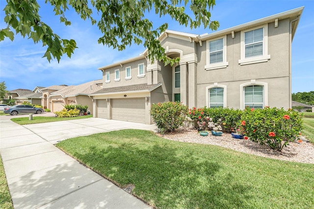 view of front of house with a garage, driveway, a front lawn, and stucco siding