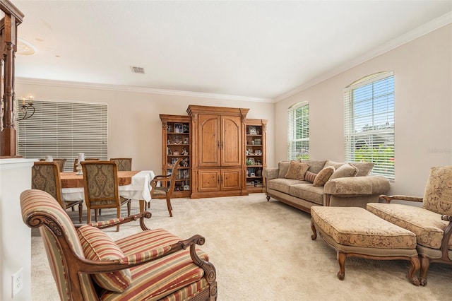 living room featuring light colored carpet, ornamental molding, a notable chandelier, and visible vents