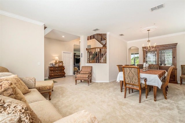 dining room featuring arched walkways, ornamental molding, a chandelier, and visible vents