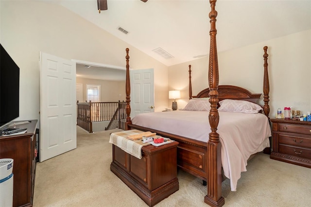 bedroom with visible vents, ceiling fan, vaulted ceiling, and light carpet