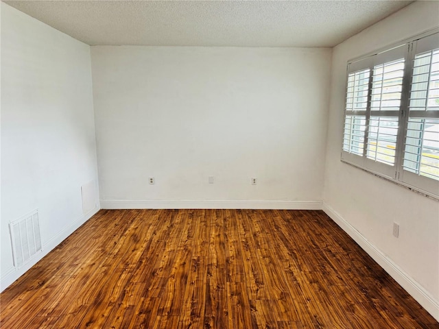 5660 80th St N Unit C101, Saint Petersburg, FL 33709 - empty room with visible vents, baseboards, a textured ceiling, and wood finished floors