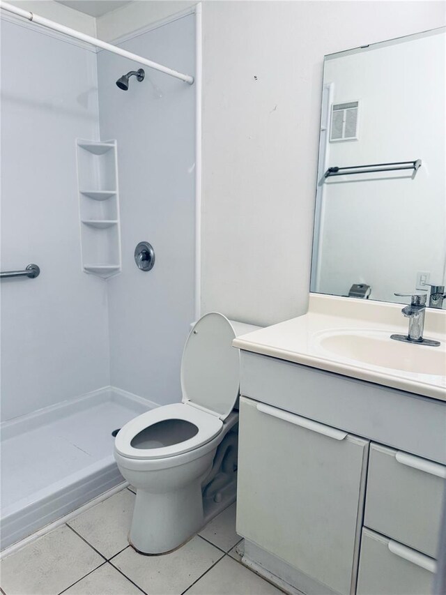 5660 80th St N Unit C101, Saint Petersburg, FL 33709 - bathroom with toilet, tile patterned floors, a shower stall, and vanity
