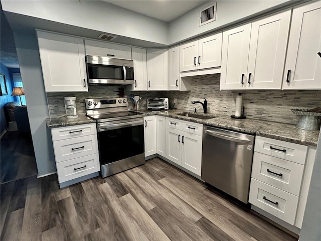 2020 World Parkway Blvd Unit 14, Clearwater, FL 33763 - kitchen featuring white cabinetry, a sink, appliances with stainless steel finishes, and visible vents