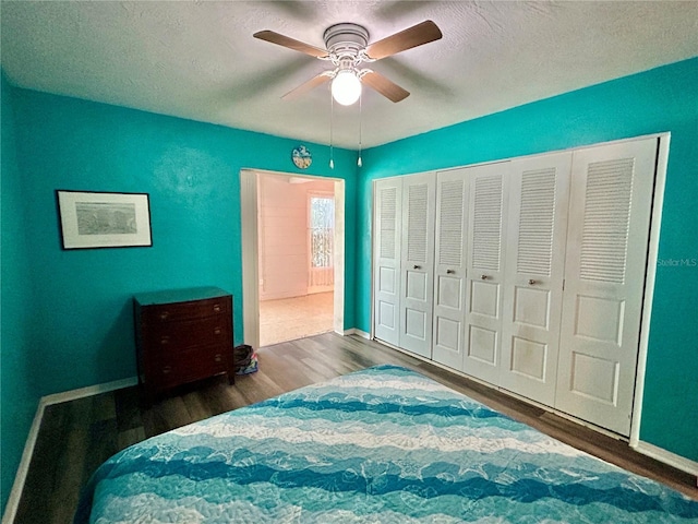 2020 World Parkway Blvd Unit 14, Clearwater, FL 33763 - bedroom featuring a textured ceiling, wood finished floors, a closet, and baseboards