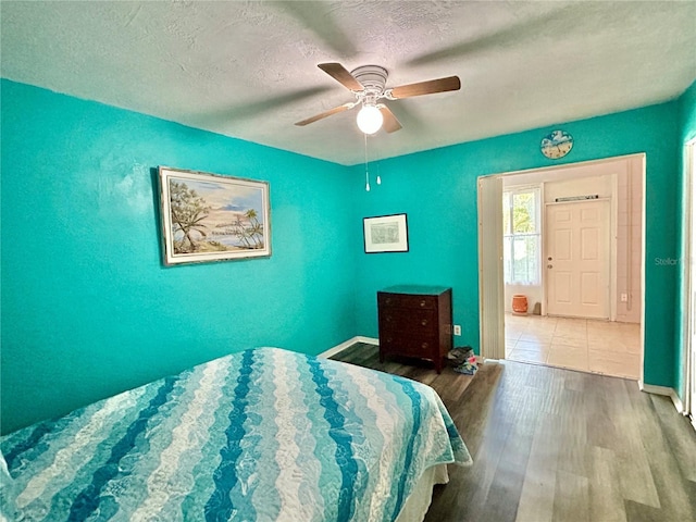 2020 World Parkway Blvd Unit 14, Clearwater, FL 33763 - bedroom featuring a textured ceiling, a ceiling fan, wood finished floors, and baseboards