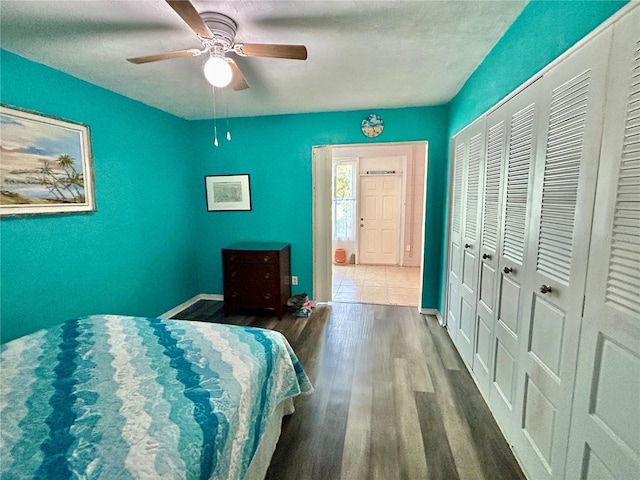 2020 World Parkway Blvd Unit 14, Clearwater, FL 33763 - bedroom featuring wood finished floors, a ceiling fan, baseboards, and a closet