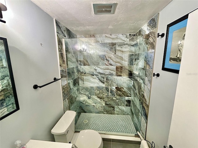 2020 World Parkway Blvd Unit 14, Clearwater, FL 33763 - bathroom featuring toilet, a stall shower, a textured ceiling, and visible vents