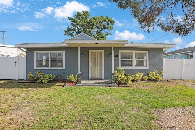 view of front of home featuring stucco siding and fence
