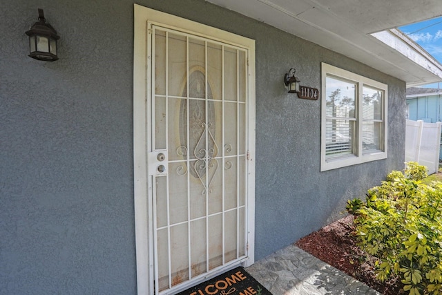 entrance to property with stucco siding
