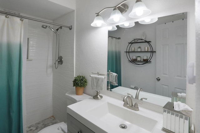 full bathroom featuring toilet, a chandelier, tiled shower, and vanity