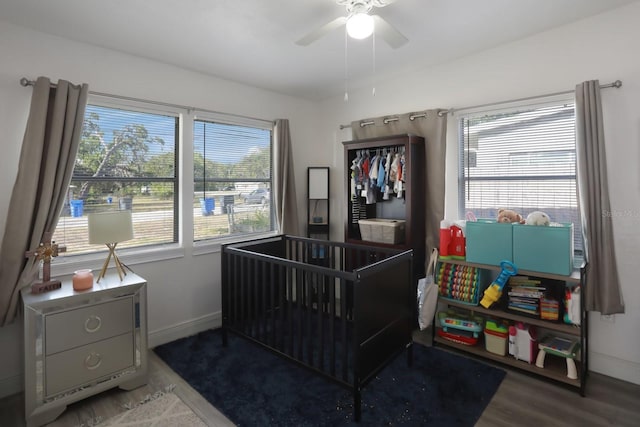 bedroom featuring baseboards, wood finished floors, and ceiling fan