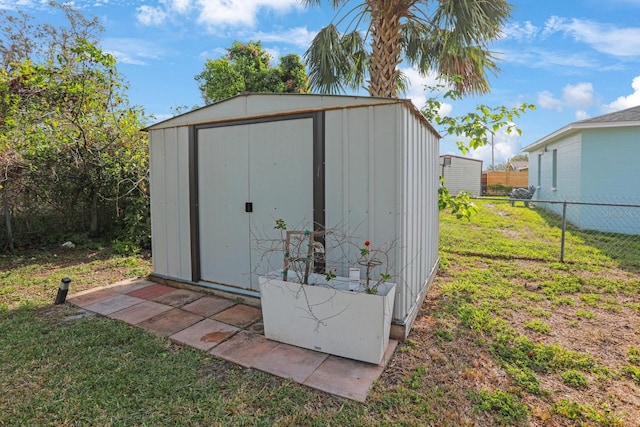 view of shed with fence