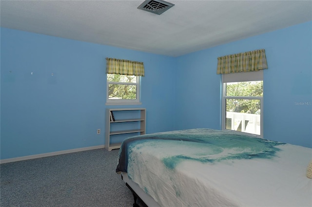 bedroom with visible vents, carpet, and baseboards