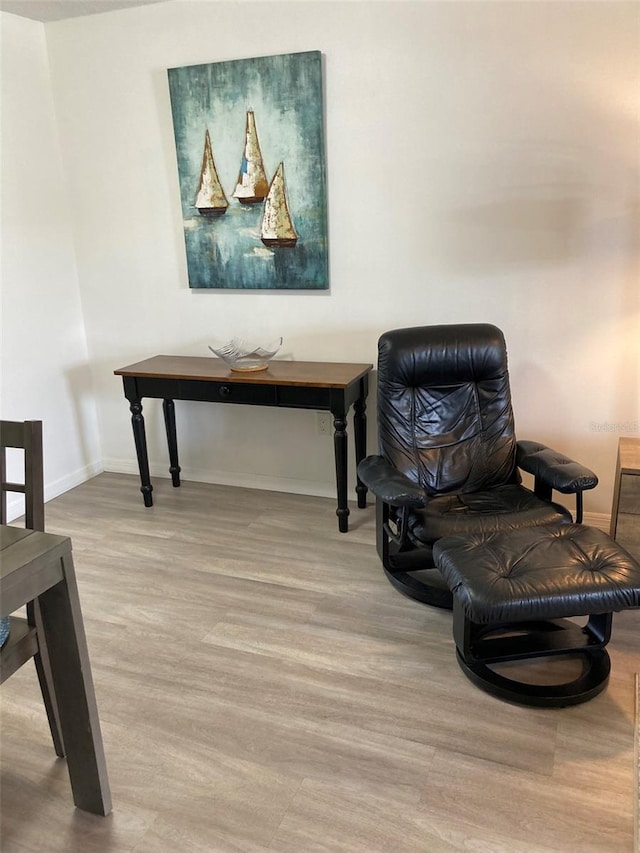7951 58th Ave N Unit 308, Saint Petersburg, FL 33709 - sitting room featuring baseboards and wood finished floors