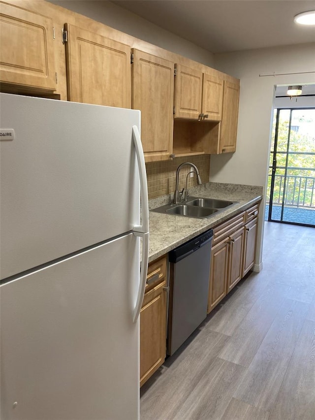 7951 58th Ave N Unit 308, Saint Petersburg, FL 33709 - kitchen featuring freestanding refrigerator, dishwasher, a sink, light wood-type flooring, and light countertops