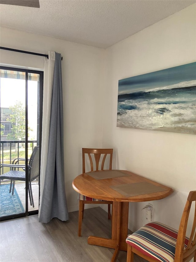 7951 58th Ave N Unit 308, Saint Petersburg, FL 33709 - dining area with wood finished floors and a textured ceiling